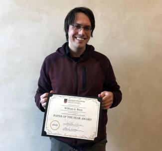 Bill Ricci posing with Paper of the Year Award