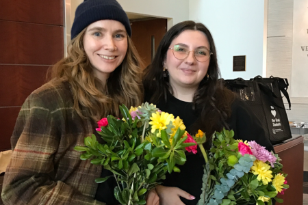 A photo of Liz and Deanna holding flowers